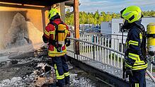 Die in Brand geratenen Paletten-Balkon-Möbel und Glutnester wurden mit Wasser abgelöscht.