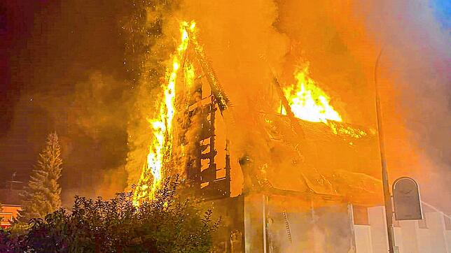 Flammen schlagen aus der katholischen Kirche St. Josef. Nach dem Dachstuhl brannte das ganze Gebäude nieder. Auch zwei davor geparkte ...