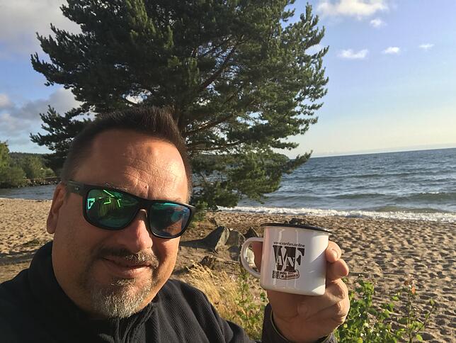 Thomas Lengsfeld zeigt einen Becher mit dem Van-Fan-Logo.