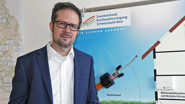 Zweckverband Geschäftsführer Jochen Cabanis steht vor einer Infotafel zum Breitbandausbau mit Glasfaser. Bild: Jens Fröhlich