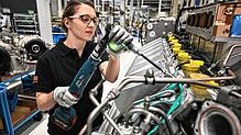Eine Mitarbeiterin von Rolls Royce Power Systems baut einen Motor der MTU-Baureihe 2000 zusammen.