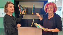 Bibliotheksleiterin Yvonne Radzuweit (links) und Kulturamtsleiterin Kerstin Simon stehen vor dem sogenannten intelligenten ...