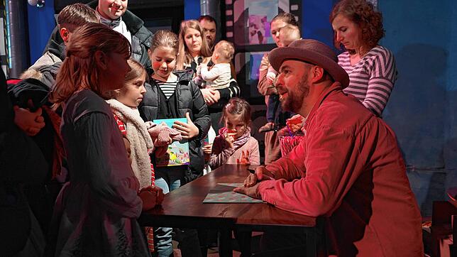 Autogrammstunde nach der Lesung: Für eine Widmung von Max Mutzke und eine Zuckerstange warten die jungen Besucher geduldig.