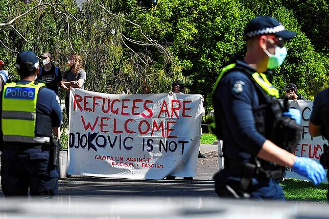 Flüchtlingsbefürworter tragen Transparente vor der Quarantäneeinrichtung des Park Hotels, in dem der serbische Tennisspieler Djokovic in ...