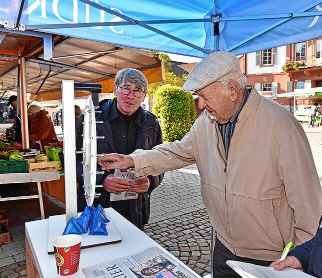Erhard Elsässer, hier mit Peter Thum vom SÜDKURIER, dreht das Glücksrad.