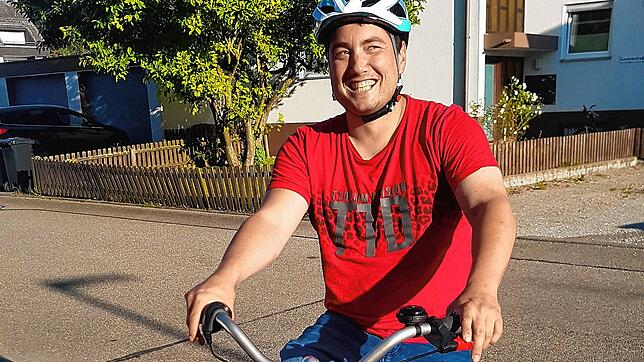 Benjamin freut sich über sein neues Dreirad. Er ist körperlich eingeschränkt und nutzt das Rad, um von A nach B zu kommen.
