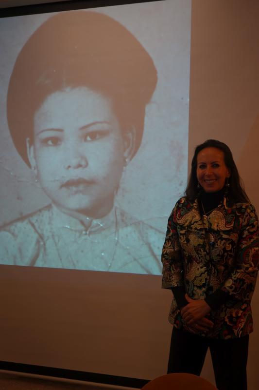Isabelle Müller in der Engener Stadtbibliothek vor einem Bild ihrer vietnamesischen Mutter, deren Leben sie literarisch verarbeitet hat. ...