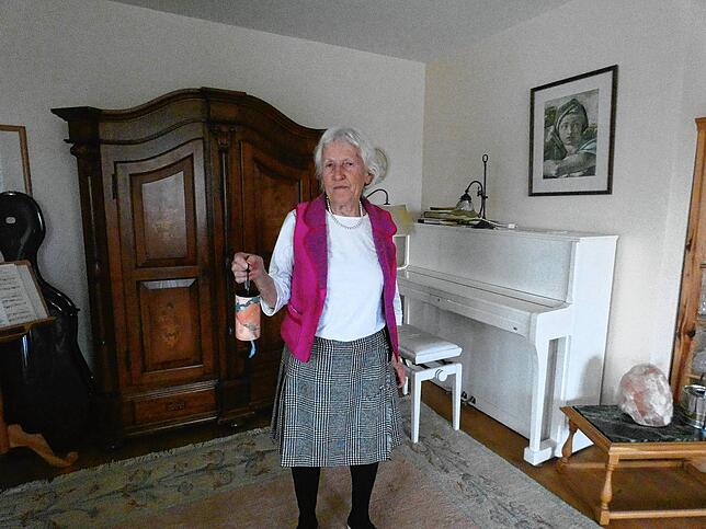 Roswitha Leonhard-Gundel in Ihrem Wohnzimmer, das sie für Märchenstunden mit Tüchern, Lichter und Kerzen schmückt. In der Hand hält sie ...