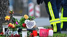 Kerzen und Blumen liegen an einem Baum an der Gesamtschule Freudenberg. Mit einer Trauerfeier nahmen Ende März Angehörige der getöteten ...
