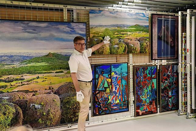 Museumsleiter Christoph Bauer erläutert im Depot des Singener Kunstmuseums, warum die Werke nur mit Handschuhen angefasst werden sollten.
