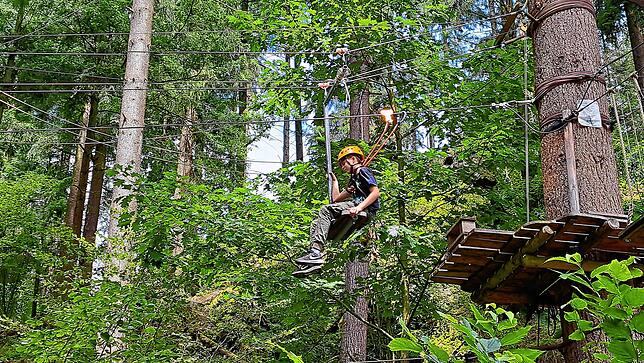 Mit einer Rutsche am Seil geht es von einem Baum zum anderen.