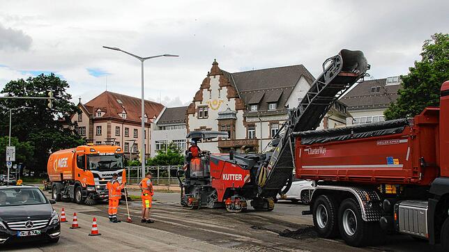 Die Arbeiten auf der Bertholdstraße haben begonnen. Während die Feinfräse (Mitte) die Spurrillen beseitigt, gelangt das abgetragene ...