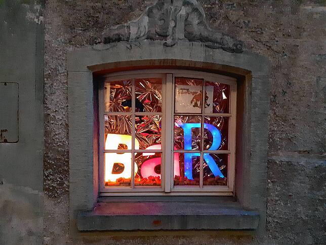 Bunt beleuchtet ist das Fenster der Salmigrotte im Untergeschoss des Museums Schiff.