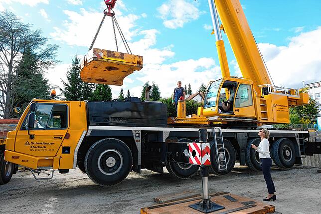 An der Baustelle angekommen, wird ein 30 Tonnen schweres Gegengewicht auf den Autokran geladen. Thomas Hager erklärt: &bdquo;Es ist ...