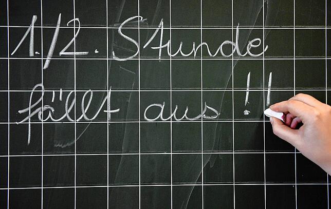Eine Lehrerin schreibt in einer Grundschule den Satz &bdquo;1./2. Stunde fällt aus!!&ldquo; an die Tafel. Die GEW in Südbaden ärgert ...
