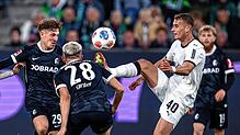 Philipp Treu (SC Freiburg) (l-r), Matthias Ginter (SC Freiburg) und Jan Urbich (Bor. Mönchengladbach) kämpfen um den Ball.